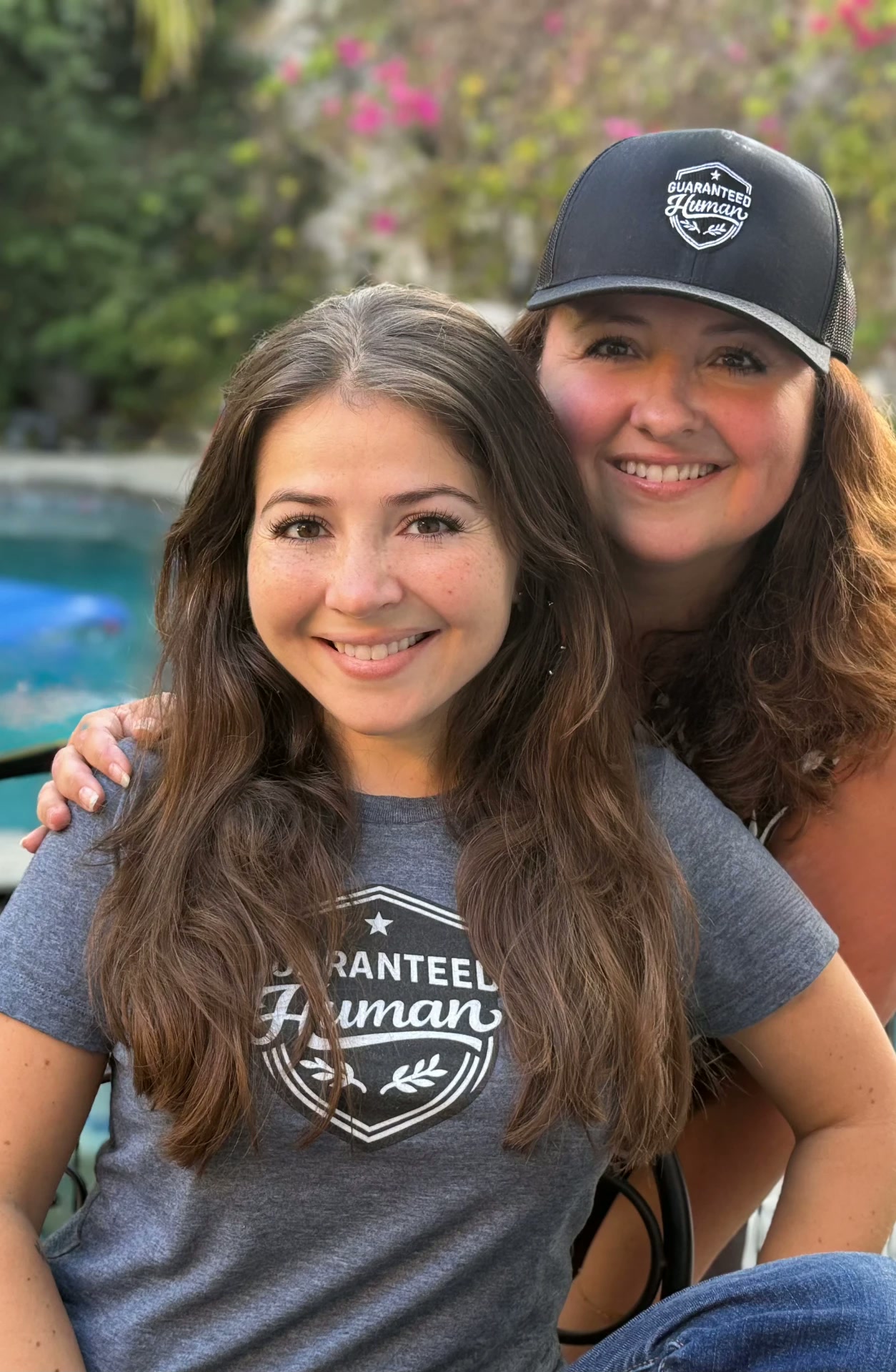 Jen and Karine today, wearing Guaranteed Human™ crest tee and cap, 2026